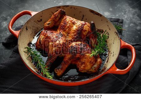 Grilled Fried Roast Chicken Tabaka In Frying Pan With Rosemary