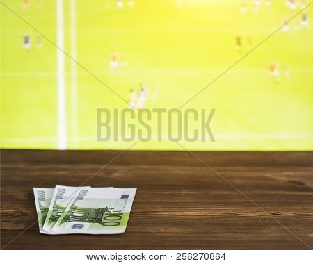 Euro Money On The Background Of The Tv On Which Show Gaelic Football, Sports Betting, Gaelic Footbal
