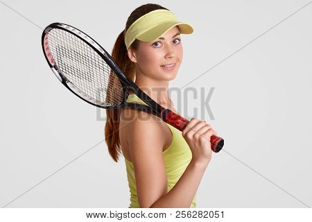 Attractive Sporty Woman With Clean Skin, Wears Casual Clothing, Holds Tennis Raquet, Has Pony Tail, 