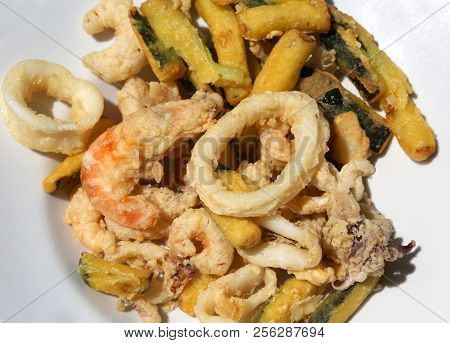 Battered Vegetables And Deep Fried Fish On The Plate At Restaurant