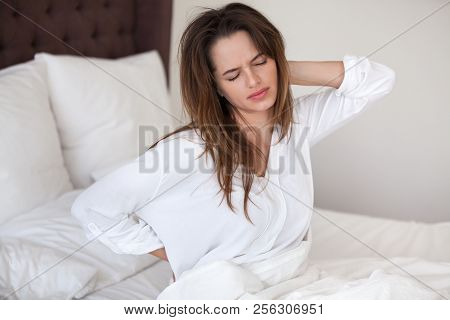 Unhappy Woman Waking Up In Bed Feeling Neck Back Pain
