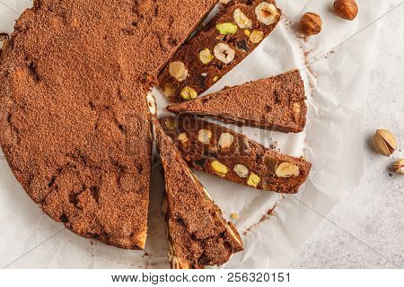 Italian Dessert Panforte With Nuts, Chocolate And Candied Fruits. White Background, Top View, Italia