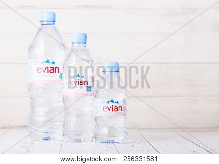 London, Uk - September 03, 2018: Plastic Bottles Of Evian Natural Mineral Water On A Wood. Made In F