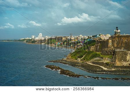 Scenic View Of Historic Colorful Puerto Rico City In Distance With Fort In Foreground