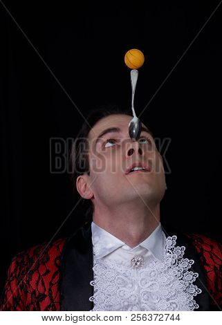 The Juggler Have A Balanse Ball On The Spoon