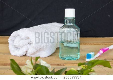 Terry Cloth ,mouthwash And Toothbrush Health Care Oral Cavity On Background Wooden