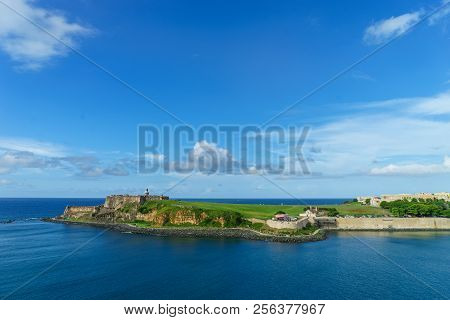 Scenic View Of Historic Colorful Puerto Rico City In Distance With Fort In Foreground From The Sea C