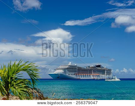 Cruise Ship In Crystal Blue Water With A Palm On The Front