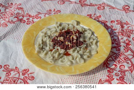 Close-up Top Shoot For Traditional Taste Turkish Ravioli With Yellow Banded Plate With Sauce