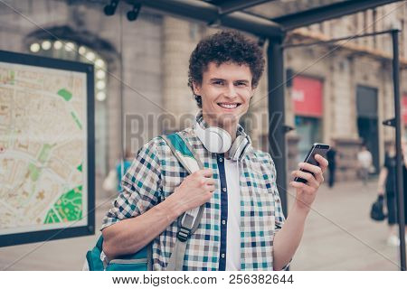 Curly Haired Cute Attractive Smiling Handsome Guy Nerd Wearing Casual Shirt On Bus Stop, Waiting For