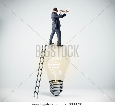 Businessman Using Binoculars While Standing On Lamp With Euro Sign And Ladder On White Background. V