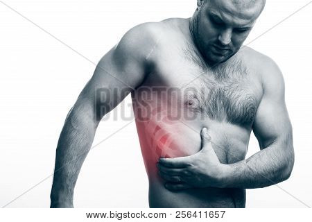 Injury Of The Rib. Young Bald Man Sportive Physique Holds On Sore Rib Isolated On White Isolated Bac
