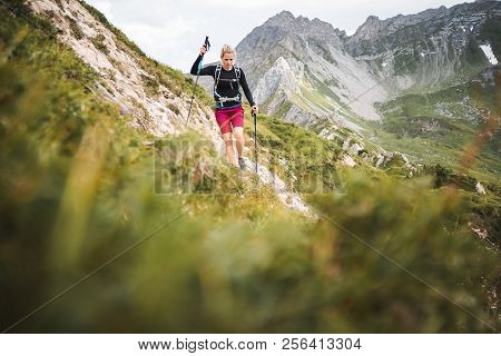 Adventurous Sportive Girl Hiking In Beautiful Alpine Mountains