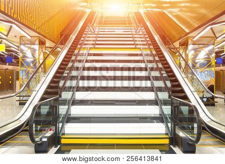 Wide Staircase And On Each Side Of It Escalators Leading Up To The Light.