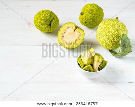 Green Fruit Of Maclura Pomifera, Osage Orange, Horse Apple, Adam Apple Grow On White Wooden Table. M