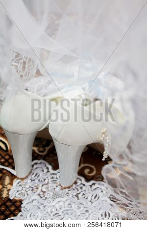 A Wedding Gentle Bouquet Of White And Pink Roses And High-heeled Shoes On A Green Grass In The Park.