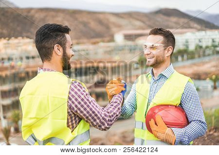 Builders On Residential Construction Site Making A Deal - Happy Workers Are Satisfied Of Their Plan 