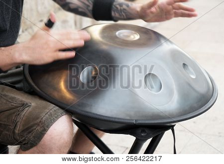 Unrecognized Man On The Street Playing Hang.