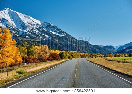Highway in Colorado Rocky Mountains at autumn, USA. Mount Sopris landscape.