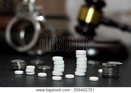 Judge's Gavel With Handcuffs, Drugs On Wooden Table