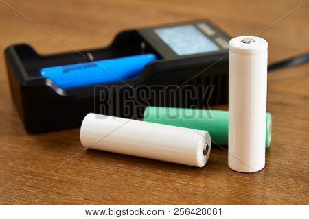 18650 Li-ion Battery Charging By Premium Charger  On A Table