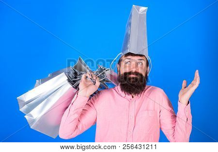 Man With Beard And Mustache Carries Shopping Bags, Blue Background. Shopping Concept. Hipster On Dea