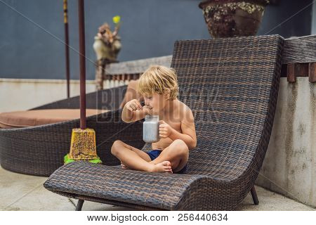 The Boy Eats Chia Pudding In The Morning By The Pool. Healthy Breakfast. Useful Food For Children