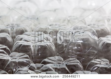 Close Up Oblique Angle Of The Bottoms Of Upturned Empty Plastic Bottles Backlit With Copy Space In A