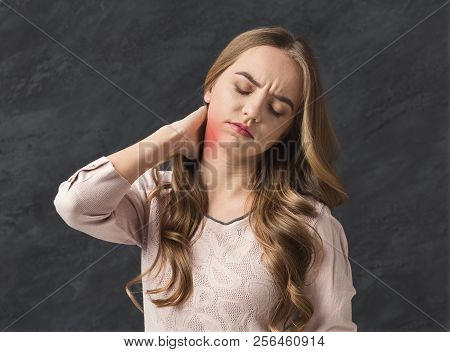 Body Pain. Beautiful Young Woman Suffering From Neck Ache. Red Spot On Neck, Dark Studio Background