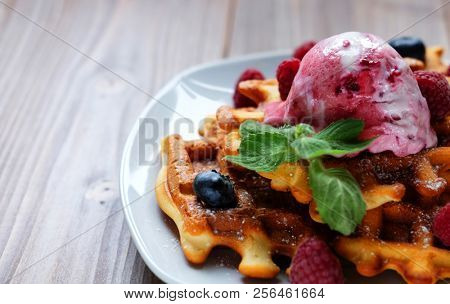 Belgian waffles with fresh berries and ice cream close up