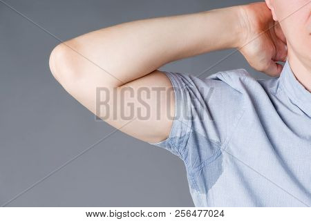 Man With Sweaty Armpits, Studio Shot On Gray Background