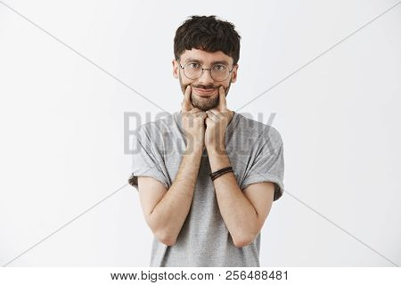 Man Putting On Smile While Feeling Gloomy Upset Pulling Corners Of Lips Aside And Staring Indifferen