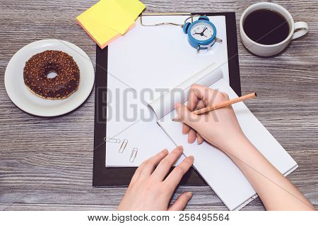 A Closeup Of Female's Hands Writing With A Pencil In A Notepad. Office Concept, Office Accessorise