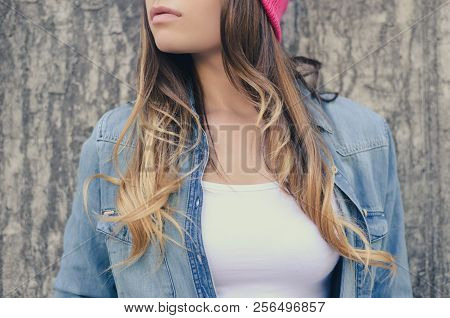 Stylish Hipster Woman With Long Hair In Jeans Clothing And Pink Hat, In White T-shirt Standing Again