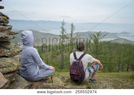 Couple Looking At Lake Baikal From Top Of The Hillock Dedicated To A Local Tutelary Deity