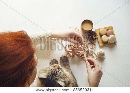 View Of Table Above Where Cat And Girl With Red Hair Drink Coffee And Unravel Tangle. Spotted Kitty 