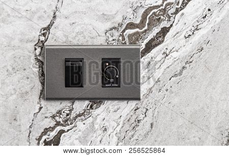 Light And Dimmer Switches On Stone Wall