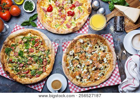 Breakfast Gourmet Pizzas With Eggs, Ham And Lox On The Table Overhead View