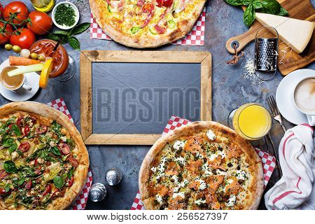 Breakfast Gourmet Pizzas With Eggs, Ham And Lox On The Table Overhead View With Copyspace
