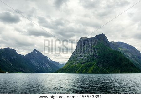 Dramatic evening view of Hjorundfjorden fjord near Urke village, Norway