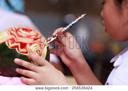 Asian Little Girl Carve Fruit In School