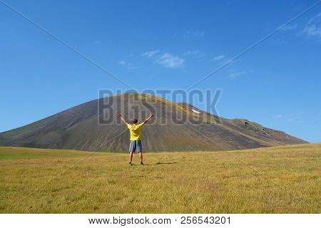 Young Man On A Hiking Trail Leading From Azhdahak Volcano To Lake Akna In Geghama Mountains Full Of