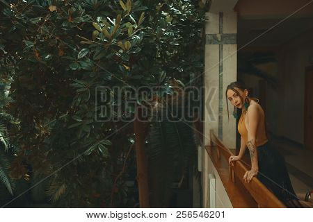 Pretty Young Woman Standing In Hotel Balcony, Looking Out Enjoyi