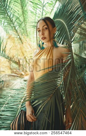Fashionable Young Woman Among The Tropical Plants.