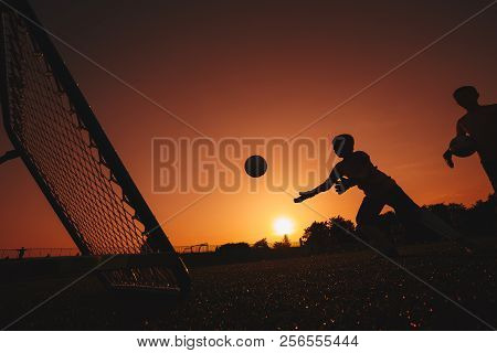 Football Soccer Goalkeeper Training Session. Two Young Goalies Practising In A Field. Soccer Equipme