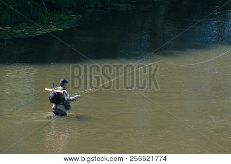 The Fisherman Catches Fish By Fly Fishing