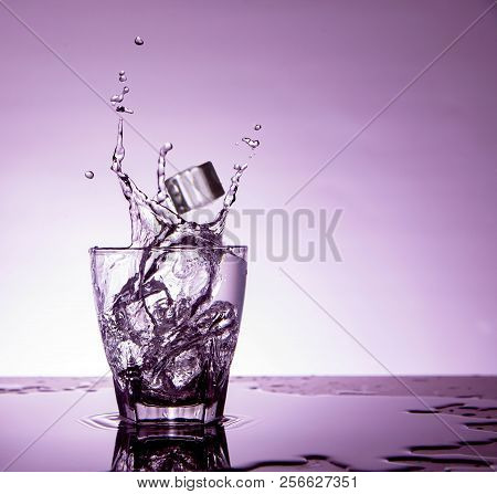 Splash Action In Glases At Water And Ice Cube
