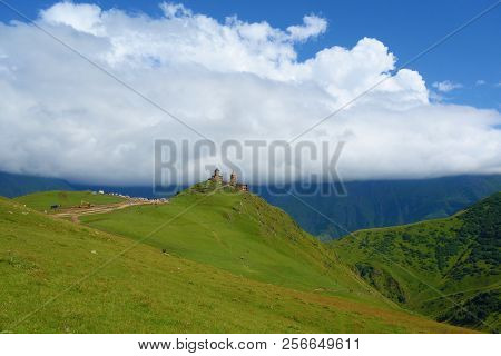 Ancient Gergeti Trinity Church Tsminda Sameba In Caucasus Mountains Near Mount Kazbek And Gergeti Gl