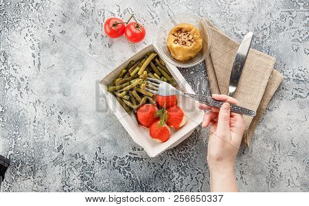Boiled String Beans, Fish Balls In Sauce And Baked Apple In Lunchbox On A Gray Background. Healthy F