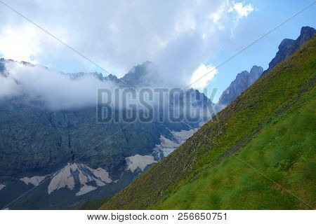 Descend From A Chaukhi Mountain Pass On A Hiking Trail Leading From Juta To Roshka In Caucasus Mount